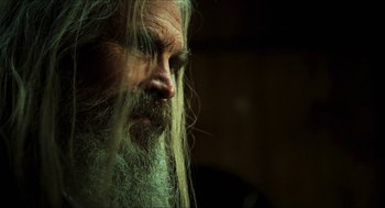 Movie still from “3 from Hell” (2019), directed by Rob Zombie – A man with long hair and beard; Close Up shot, Low angle