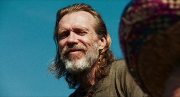 Movie still from “3 from Hell” (2019), directed by Rob Zombie – A person with long hair and a beard; Close Up shot, Over the shoulder angle