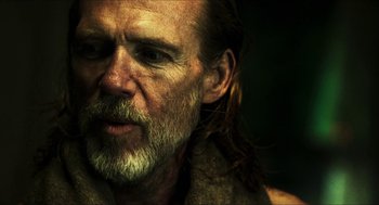 Movie still from “3 from Hell” (2019), directed by Rob Zombie – A man with long hair and beard; Close Up shot, Over the shoulder angle