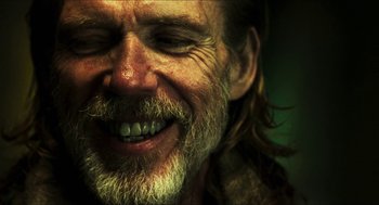 Movie still from “3 from Hell” (2019), directed by Rob Zombie – An old man with a long beard smiling for the camera; Close Up shot, Low angle
