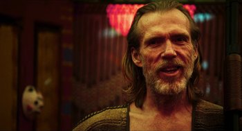 Movie still from “3 from Hell” (2019), directed by Rob Zombie – A person with long hair and a beard; Close Up shot, Over the shoulder angle