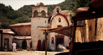 Movie still from “3 from Hell” (2019), directed by Rob Zombie – An old building with a bell tower in the middle of it; Extreme Wide shot, Low angle