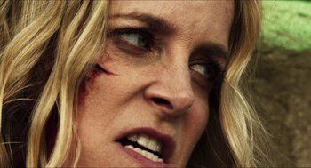 Movie still from “3 from Hell” (2019), directed by Rob Zombie – A person with a bruise on her face; Extreme Close Up shot, Low angle