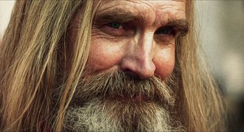 Movie still from “3 from Hell” (2019), directed by Rob Zombie – A man with a long beard; Extreme Close Up shot, Low angle