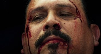 Movie still from “3 from Hell” (2019), directed by Rob Zombie – A person with blood all over his face; Extreme Close Up shot, Low angle