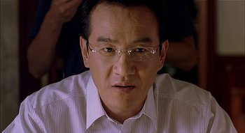 Movie still from “3-Iron” (2004), directed by Kim Ki-duk – A person wearing glasses and a white shirt; Close Up shot, Low angle