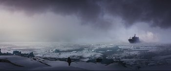 Movie still from “30 Days of Night” (2007), directed by David Slade – A large body of water covered in snow under a cloudy sky; Extreme Wide shot, Low angle