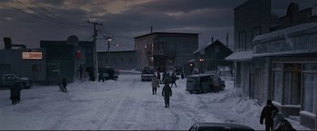 Movie still from “30 Days of Night” (2007), directed by David Slade – A group of people walking down a snowy street; Extreme Wide shot, High angle