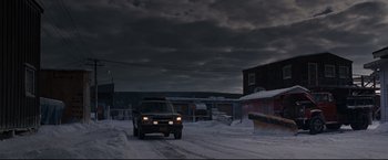 Movie still from “30 Days of Night” (2007), directed by David Slade – A truck driving down a snow covered street; Extreme Wide shot, Low angle