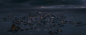 Movie still from “30 Days of Night” (2007), directed by David Slade – A view of a city at night from a hill; Extreme Wide shot, High angle