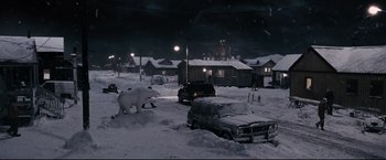 Movie still from “30 Days of Night” (2007), directed by David Slade – A polar bear walking across a snow covered street; Extreme Wide shot, High angle