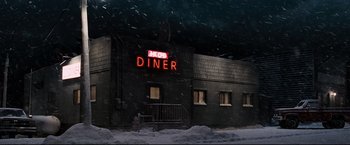 Movie still from “30 Days of Night” (2007), directed by David Slade – A diner is lit up at night in the snow; Extreme Wide shot, Low angle