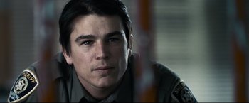 Movie still from “30 Days of Night” (2007), directed by David Slade – A person wearing a police uniform; Close Up shot, Low angle