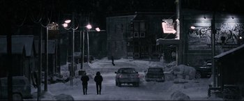 Movie still from “30 Days of Night” (2007), directed by David Slade – Two people walking down a street in the snow; Extreme Wide shot, High angle