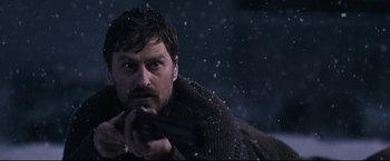 Movie still from “30 Days of Night” (2007), directed by David Slade – A man with a gun in his hand in the snow; Close Up shot, Low angle