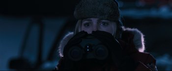 Movie still from “30 Days of Night” (2007), directed by David Slade – A woman looking through binoculars while wearing a hat; Close Up shot, Over the shoulder angle