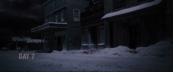 Movie still from “30 Days of Night” (2007), directed by David Slade – A street scene with snow on the ground and buildings in the background; Extreme Wide shot, High angle