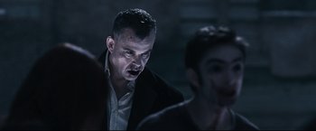Movie still from “30 Days of Night” (2007), directed by David Slade – A person wearing a suit and tie; Medium shot, Over the shoulder angle