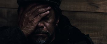 Movie still from “30 Days of Night” (2007), directed by David Slade – A person holding his hand to his face; Close Up shot, High angle