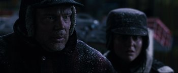Movie still from “30 Days of Night” (2007), directed by David Slade – A person wearing a hat with snow on it; Close Up shot, Over the shoulder angle