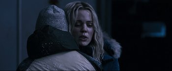 Movie still from “30 Days of Night” (2007), directed by David Slade – A woman in a parka is hugging a man; Close Up shot, Over the shoulder angle