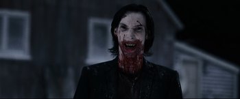 Movie still from “30 Days of Night” (2007), directed by David Slade – A man with blood on his face and teeth; Close Up shot, Over the shoulder angle