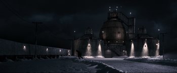 Movie still from “30 Days of Night” (2007), directed by David Slade – A man riding skis on top of a snow covered slope; Extreme Wide shot, Low angle
