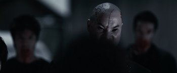 Movie still from “30 Days of Night” (2007), directed by David Slade – A man with a shaved head is looking at the camera; Extreme Close Up shot, Over the shoulder angle