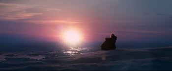 Movie still from “30 Days of Night” (2007), directed by David Slade – A person sitting in the middle of the ocean at sunset; Extreme Wide shot, Low angle