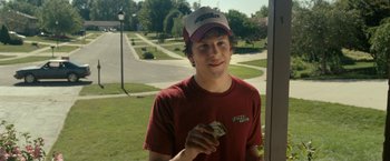 Movie still from “30 Minutes or Less” (2011), directed by Ruben Fleischer – A young man holding a piece of paper in his hand; Medium shot, Over the shoulder angle