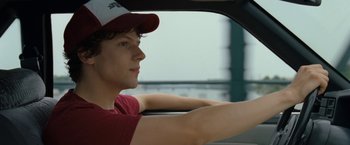 Movie still from “30 Minutes or Less” (2011), directed by Ruben Fleischer – A man sitting in the driver's seat of a car; Close Up shot, Over the shoulder angle