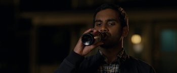 Movie still from “30 Minutes or Less” (2011), directed by Ruben Fleischer – A man is drinking a beer from a bottle; Close Up shot, High angle
