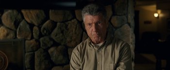 Movie still from “30 Minutes or Less” (2011), directed by Ruben Fleischer – An older man wearing a tan shirt and a brown shirt; Close Up shot, Low angle