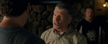 Movie still from “30 Minutes or Less” (2011), directed by Ruben Fleischer – An older man in front of a pile of wood; Close Up shot, Over the shoulder angle
