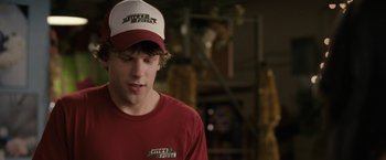 Movie still from “30 Minutes or Less” (2011), directed by Ruben Fleischer – A young man wearing a red shirt and a white hat; Close Up shot, Over the shoulder angle