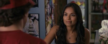 Movie still from “30 Minutes or Less” (2011), directed by Ruben Fleischer – A beautiful young woman sitting in front of a wall; Close Up shot, Over the shoulder angle