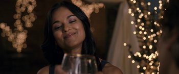 Movie still from “30 Minutes or Less” (2011), directed by Ruben Fleischer – A woman holding a wine glass in front of her face; Close Up shot, Over the shoulder angle