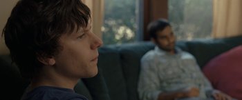 Movie still from “30 Minutes or Less” (2011), directed by Ruben Fleischer – Two men are sitting in a chair and one is looking at the camera; Close Up shot, Over the shoulder angle