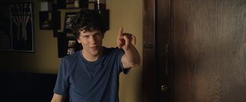 Movie still from “30 Minutes or Less” (2011), directed by Ruben Fleischer – A young man holding up his middle finger; Medium shot, Over the shoulder angle
