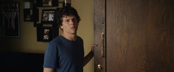 Movie still from “30 Minutes or Less” (2011), directed by Ruben Fleischer – A man standing in front of an open door; Medium shot, Over the shoulder angle