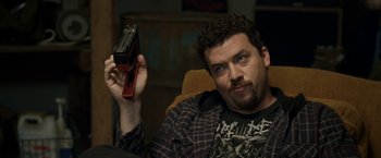 Movie still from “30 Minutes or Less” (2011), directed by Ruben Fleischer – A man holding a camera in his hand; Close Up shot, High angle