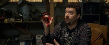 Movie still from “30 Minutes or Less” (2011), directed by Ruben Fleischer – A man holding a pair of scissors in his hand; Close Up shot, High angle