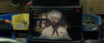Movie still from “30 Minutes or Less” (2011), directed by Ruben Fleischer – A man wearing a chef's hat in front of an oven; Close Up shot, Over the shoulder angle