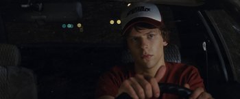 Movie still from “30 Minutes or Less” (2011), directed by Ruben Fleischer – A man in a baseball cap holding a car key; Close Up shot, Over the shoulder angle