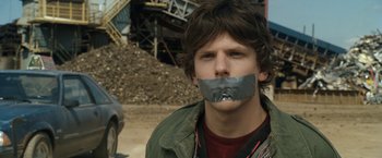 Movie still from “30 Minutes or Less” (2011), directed by Ruben Fleischer – A young man with duct tape over his mouth; Close Up shot, Over the shoulder angle