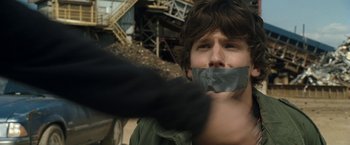 Movie still from “30 Minutes or Less” (2011), directed by Ruben Fleischer – A man with duct tape around his mouth; Close Up shot, Over the shoulder angle