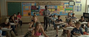 Movie still from “30 Minutes or Less” (2011), directed by Ruben Fleischer – A group of students sitting at desks in a classroom; Wide shot, Over the shoulder angle
