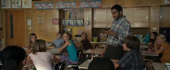 Movie still from “30 Minutes or Less” (2011), directed by Ruben Fleischer – A group of kids in a classroom with a man in the background; Medium shot, Over the shoulder angle