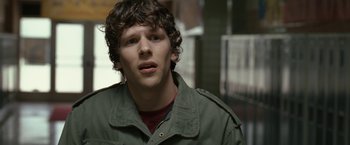 Movie still from “30 Minutes or Less” (2011), directed by Ruben Fleischer – A man with curly brown hair wearing a green jacket; Close Up shot, Over the shoulder angle