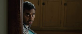 Movie still from “30 Minutes or Less” (2011), directed by Ruben Fleischer – A person wearing a shirt; Close Up shot, Over the shoulder angle